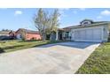 House exterior with a long driveway and neighboring homes at 839 Franconville Ct, Kissimmee, FL 34759