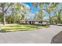 Landscaped yard and home exterior with a long driveway at 1660 Killean Ct, Apopka, FL 32712