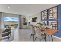 Open concept dining area with wood table and modern art at 2921 Hudson Hammock Way, St Cloud, FL 34773