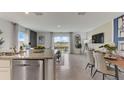 Modern kitchen island with granite countertops and stainless steel appliances at 2921 Hudson Hammock Way, St Cloud, FL 34773
