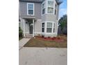 Two-story house with gray siding, landscaping, and a front entrance at 4530 Brook Hollow Cir, Winter Springs, FL 32708