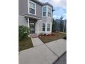 Two-story house with gray siding, landscaping, and a front entrance at 4530 Brook Hollow Cir, Winter Springs, FL 32708
