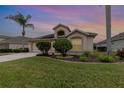 House exterior at sunset with manicured lawn and landscaping at 533 Arena Dr, Davenport, FL 33837