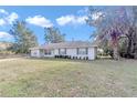 House exterior showcasing a ranch style home with a large front yard at 5724 Se 2Nd St, Ocala, FL 34480