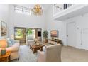 Spacious living room with vaulted ceilings and access to a patio at 104 Coventry Ln, Haines City, FL 33844