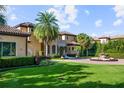 Stunning home showcasing Mediterranean architecture and landscaping at 11103 Bridge House Rd, Windermere, FL 34786