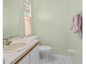 Small bathroom with single sink vanity and toilet at 112 Blackwater Ct, Kissimmee, FL 34743