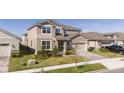 Two-story house with a two-car garage and landscaped front yard at 1798 Flourish Ave, Kissimmee, FL 34744
