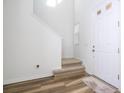 Modern staircase with carpeted steps and wood-look flooring at 1798 Flourish Ave, Kissimmee, FL 34744