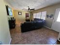 Living room with leather furniture and tile floors at 206 Cooke St, Leesburg, FL 34748