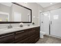 Modern bathroom with dark wood cabinets and a walk-in shower at 218 Brooke'S Pl, Haines City, FL 33844