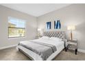 Spacious bedroom with a gray upholstered bed and window blinds at 218 Brooke'S Pl, Haines City, FL 33844