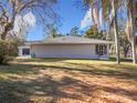 The house exterior shows a large backyard with mature trees at 23917 Kays Way, Astatula, FL 34705