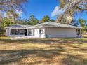 This charming house features a large backyard and screened patio area at 23917 Kays Way, Astatula, FL 34705