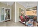 Relaxing front porch with rocking chairs and ceiling fan at 24946 Cranes Roost Circle, Leesburg, FL 34748