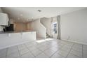 Open concept living area with tile floors and kitchen access at 251 Blueberry Ln, Davenport, FL 33837