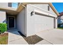 Front entryway with walkway leading to the garage at 2860 Paynes Prairie Cir, Kissimmee, FL 34743