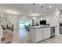 Spacious kitchen with granite countertops, island, stainless steel appliances at 7424 Oakmoss Loop, Davenport, FL 33837