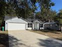 Newly built home with gray brick accents and a teal front door at 911 Pine Ave, Mount Dora, FL 32757