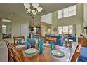 Elegant dining room set with view into the living room at 1636 Moon Valley Dr, Davenport, FL 33896