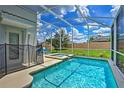 Inviting screened-in pool and spa area with lush landscaping at 1636 Moon Valley Dr, Davenport, FL 33896