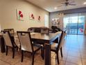 Dining area with dark wood table and six chairs, overlooking the pool at 1804 Gobi Dr, Kissimmee, FL 34747
