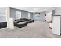 Spacious living room with gray sectional sofa and plush carpeting at 1804 Gobi Dr, Kissimmee, FL 34747