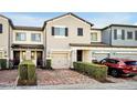 Two-story townhome with brick paver driveway and landscaping at 2766 White Isle Ln, Orlando, FL 32825