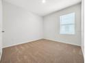 Spacious bedroom with neutral-colored walls and carpeted flooring at 418 Caraway Dr, Kissimmee, FL 34759