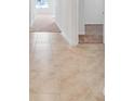Light hallway with neutral tile floors leading to carpeted rooms at 418 Caraway Dr, Kissimmee, FL 34759