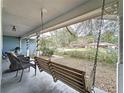 Inviting front porch with a porch swing at 1215 Timberidge Dr, Lakeland, FL 33809