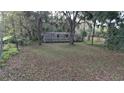 Mobile home on a large lot with surrounding trees and vegetation at 15924 Old Cheney Hwy, Orlando, FL 32833