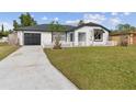 Newly renovated home with a large yard and a modern exterior at 171 Toluca Dr, Kissimmee, FL 34743