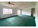 Spacious living room with green carpet and sliding glass doors at 1816 Haperon St, Apopka, FL 32703