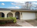 Front view of a house featuring a white door and brick walkway at 271 Fallen Palm Dr, Casselberry, FL 32707