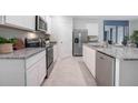 Modern kitchen with stainless steel appliances and granite countertops at 441 Cinnamon Dr, Kissimmee, FL 34759