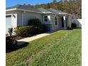 Exterior view of the house, showcasing a side yard and walkway at 4633 Glencrest Loop, St Cloud, FL 34772
