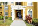 Condo building entrance with stairs and landscaping at 4814 Cayview Ave # 40613, Orlando, FL 32819