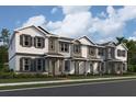 Three-story townhouses with gray and white siding, and teal doors at 592 Pothos St, Apopka, FL 32703