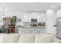 Modern kitchen with white cabinets, center island, and stainless steel appliances at 6115 Claystone Way, Mount Dora, FL 32757