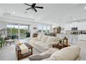 Open-concept living area with tile floors, comfortable seating, and access to a patio at 6115 Claystone Way, Mount Dora, FL 32757