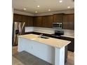 Modern kitchen featuring dark brown cabinets and a large island at 2008 Heart Lake Dr, Groveland, FL 34736