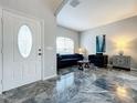 Living room with marble flooring, dark sofa and chairs at 2510 Black Lake Blvd, Winter Garden, FL 34787
