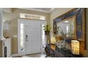 Bright and spacious entryway with decorative mirror and console table at 607 Pensacola Ln, Lake Mary, FL 32746