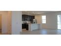 Modern kitchen with dark cabinetry, quartz countertops, and an island at 6805 Serpent Hawk Lane St, Howey In The Hills, FL 34737