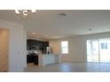 Open floor plan with modern kitchen, dining area, and access to patio at 6805 Serpent Hawk Lane St, Howey In The Hills, FL 34737