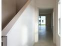 Bright foyer with tile flooring, staircase, and view into living area at 6858 Spanish Imperial St, Howey In The Hills, FL 34737
