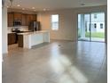 Spacious kitchen with island, stainless steel appliances, and wood cabinets at 6858 Spanish Imperial St, Howey In The Hills, FL 34737