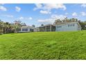 House situated on a large grassy lot with a view of the backyard at 1409 Lake Marion Dr, Apopka, FL 32712