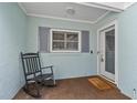 Front porch with rocking chair, inviting entryway, and welcome mat at 1409 Lake Marion Dr, Apopka, FL 32712